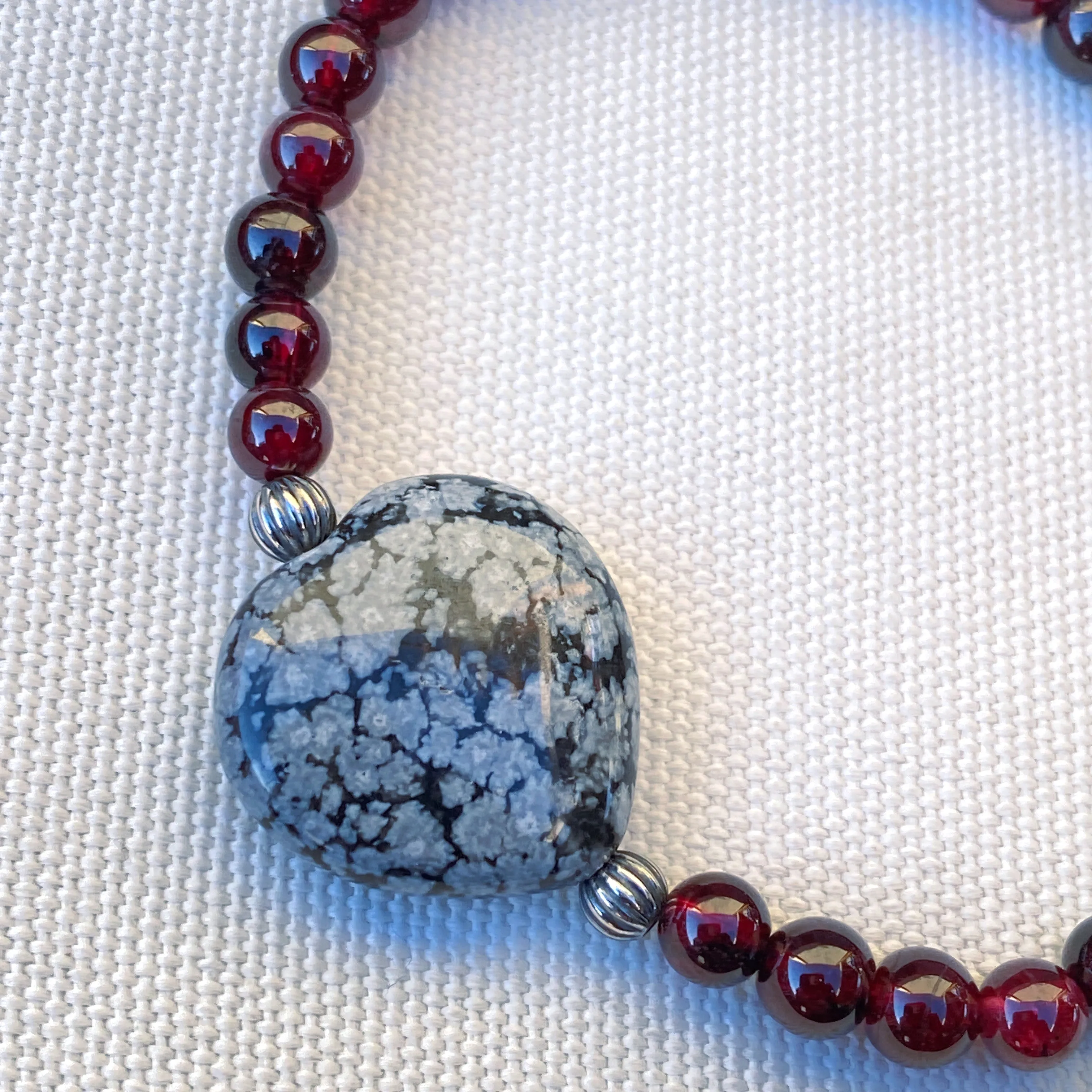 Garnet gemstones, Snowflake Obsidian Heart, and Sterling Silver Stretch Bracelet