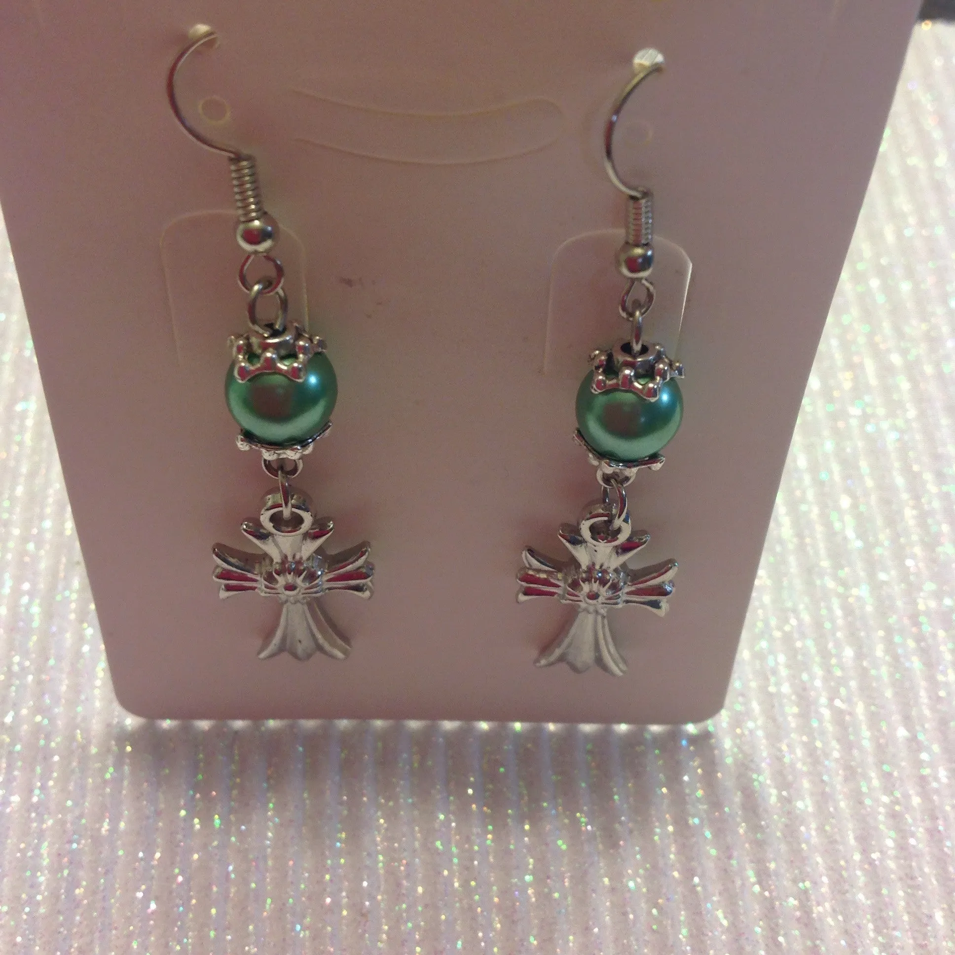 Pearl earrings with a cross charm with a flower in the center of cross