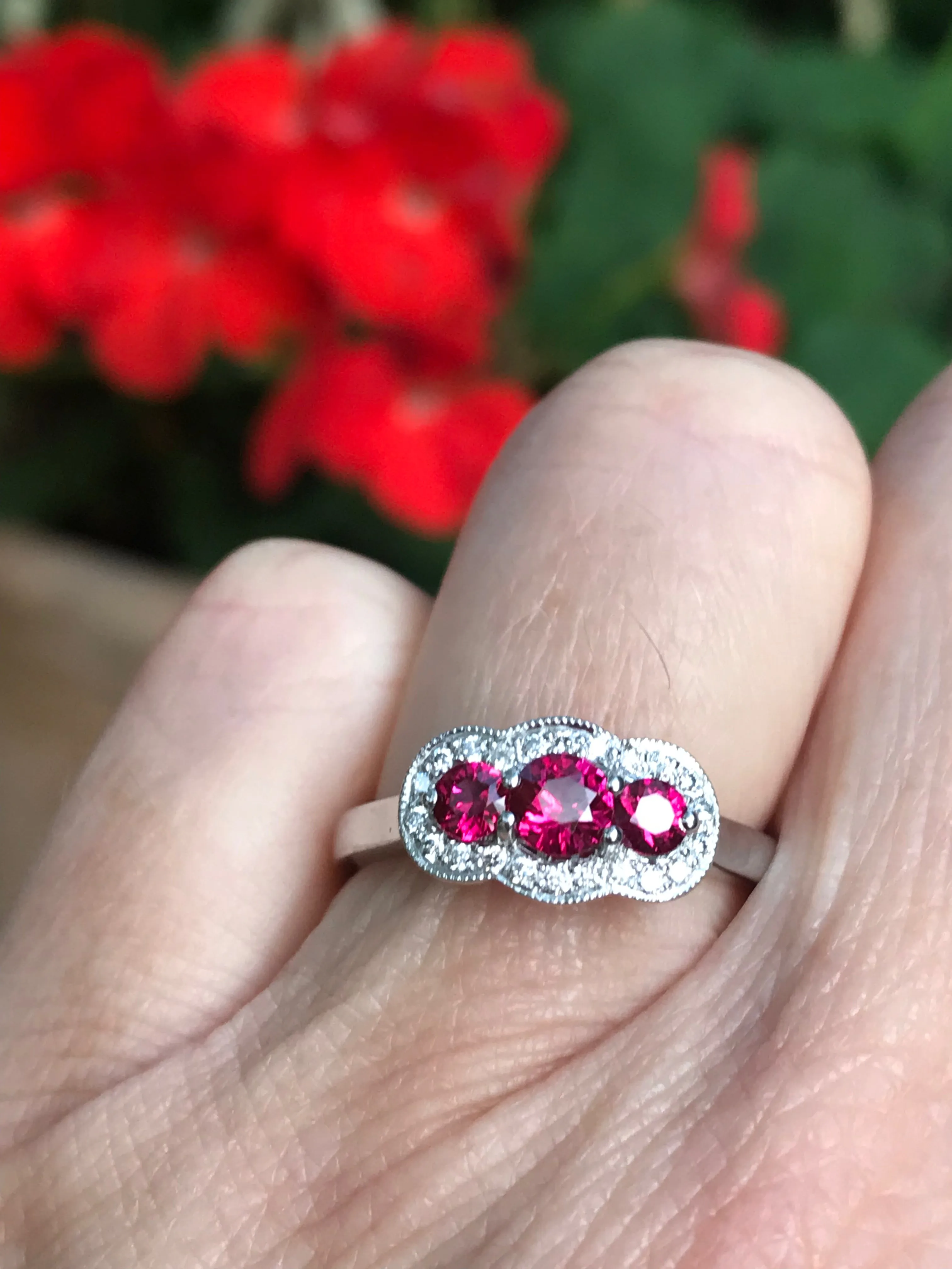 Platinum Ruby and diamond three stone halo ring